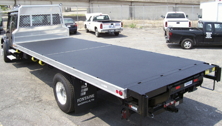 The application of bedliner material is seen here on the deck of a rollback recovery truck. (Photo courtesy of Langeman Manufacturing, LTD.)