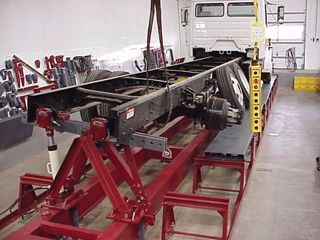 As one might suspect, frame repair equipment for the heavy truck collision repair business is much larger than the frame racks used in the repair of passenger cars. The system above is being used to push a twist out of the frame of a truck. (Photo courtesy of Bee Line Company)
