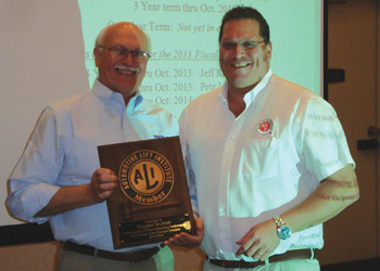 ALI President R.W. (Bob) O’Gorman (right) presents a service plaque to outgoing ALI Chairman Douglas Grunnet.  