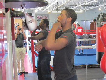 a local aspiring boxer works out at the gym at rocco’s collision.