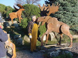 shop owner don lindgren loves his creations — and isn’t afraid to show it. george is the moose getting smooched, and mike is the moose in the background. 