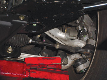 This bend in the steering arm was detected after the first attempt to align the front wheels. The result of this bent steering arm is an unequal turning radius — a condition that often goes unnoticed.
