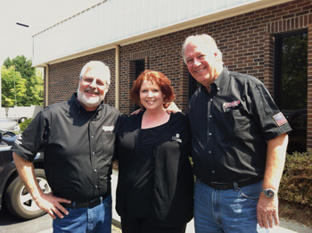 (Left to right) Sam Memmolo, co-host of Motorhead Garage, Meredith Atha, general manager of Sterling Autobody Centers and Dave Bowman, co-host of Motorhead Garage on location in Lawrenceville, Ga.