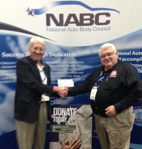 Doug Webb, CEO of TenPoint Complete, presents NABC's Chuck Sulkala with a $3,000 check for Operation Comfort at NACE.