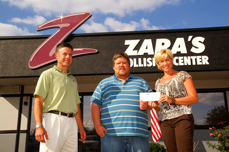 Eric Nolting, center, of Springfield receives his $500 check as the winner of the Don’t Quit Your Day Job contenst sponsored by Zara’s Collision Center. 